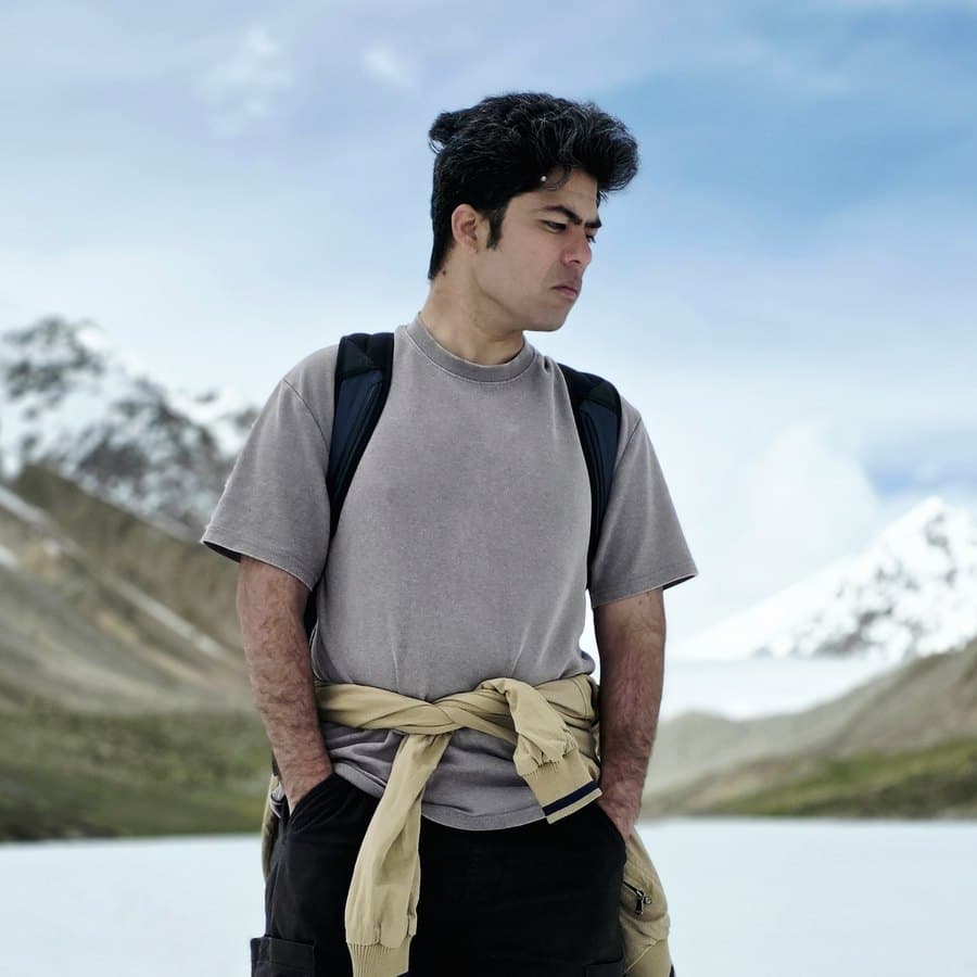 Me, standing in the snow with mountains behind